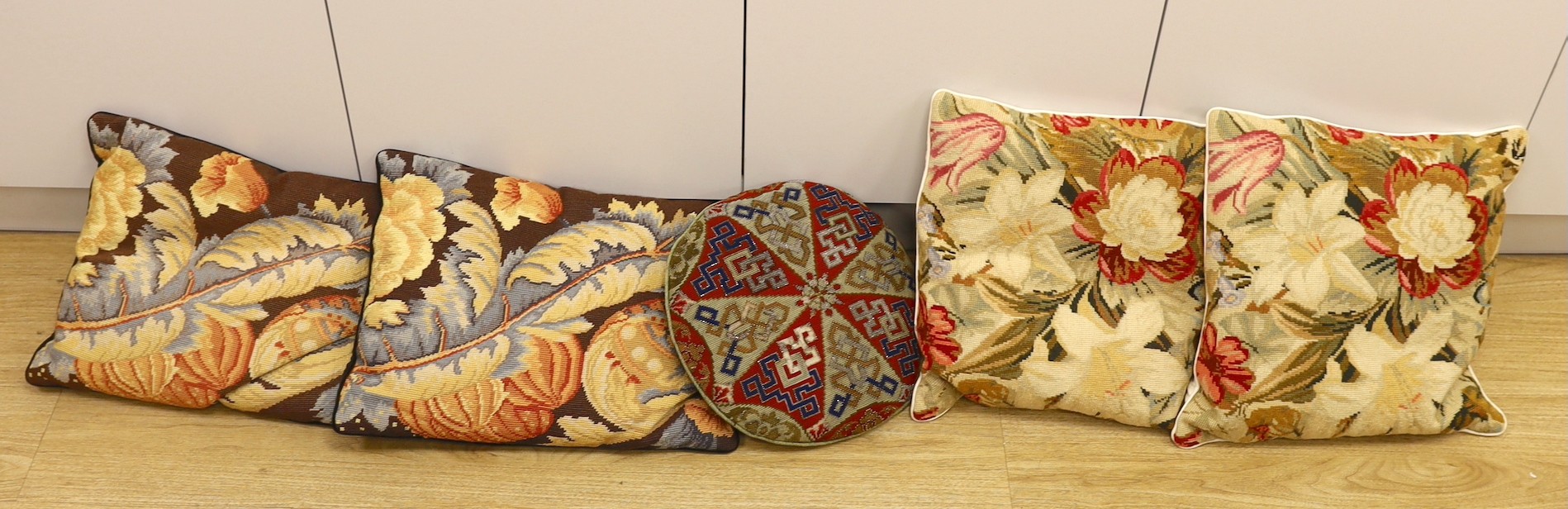 Two pairs of wool work cushions and a 19th century circular Berlin bead work cushion-Berlin bead work cushion 38cms.